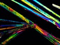 Crystal layer on microscope object glass, seen in polarized light. This causes random unforeseeable color effects