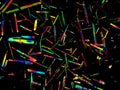 Crystal layer on microscope object glass, seen in polarized light. This causes random unforeseeable color effects