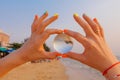 Lens ball in hand with reflection of sea and sunset on the beach Royalty Free Stock Photo