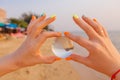 Lens ball in hand with reflection of sea and sunset on the beach Royalty Free Stock Photo