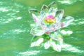 Crystal lotus on shiny green background with light reflection. Anahata chakra symbol