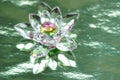 Crystal lotus on shiny green background with light reflection. Anahata chakra symbol. Esoteric, reiki energy, meditation