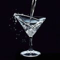 Crystal martini glass pouring refreshing cocktail, splashing liquid elegance