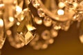 Crystal ornaments on antique chandelier. Warm white color balance. Vertical photo.