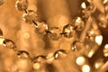 Crystal ornaments on antique chandelier. Warm white color balance. Vertical photo.