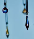 Crystal pendents hanging with a blue background