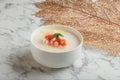 Crystal Prawn Congee served in a bowl isolated on wooden board side view dark background