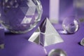 Crystal prism refracting light, magic crystals and pyramid, sphere and cube on purple background. Spiritual healing Royalty Free Stock Photo