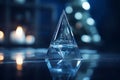 a crystal pyramid sitting on a table in front of a christmas tree