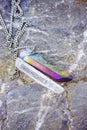 Crystal quartz necklace on rock background