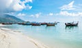 Crystal sea beach with group long tail boat anchor coast