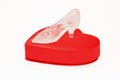 Crystal shoe on a red gift box in heart shape Royalty Free Stock Photo