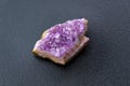 Crystal stone is a mineral. Purple rough amethyst quartz crystals, on black background Royalty Free Stock Photo