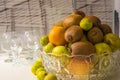 Crystal vase with fruits: kiwi, lime, orange, apple