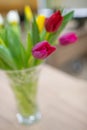 Crystal vase on the table with purple tulips. soft focus, blurred background Royalty Free Stock Photo