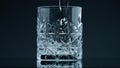 Crystal water pouring glass at dark background closeup. Fresh liquid splashing Royalty Free Stock Photo