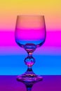 Crystal wine glass on a background of colored gradient Royalty Free Stock Photo