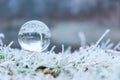 Crystall ball of a frozen nature. Winter background.