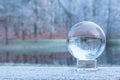 Crystall ball of a frozen nature. Winter background.