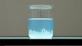 Crystallization process in blue chemical solution within glass beaker Royalty Free Stock Photo