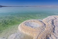 Crystallized salt cover the beach, Dead Sea in Israel.