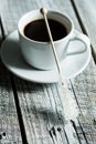 Crystallized sugar on wooden stick and coffee cup.