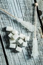 Crystallized sugar on wooden stick and sugar cubes. Royalty Free Stock Photo