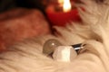 Crystals on a fur carpet. Candle burning in the background.