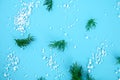 Crystals of large sea salt and dill on a blue table. Royalty Free Stock Photo