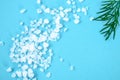 Crystals of large sea salt and dill on a blue table. Royalty Free Stock Photo