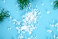 Crystals of large sea salt and dill on a blue table. Royalty Free Stock Photo