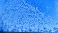 Crystals of snow and ice on the glass and blue sky in the background. Abstract frame, texture and background. Winter Royalty Free Stock Photo