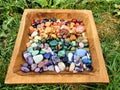 Crystals in Wooden Box : CHAKRASTONES  Polished Raw Lake Stones Gems River Water Rocks Royalty Free Stock Photo