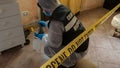 Csi crime scene investigator inspecting with blue flashlights and taking scientific evidence to take to the lab Royalty Free Stock Photo