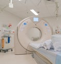 CT Scanner in hospital surrounded by other monitoring machinery.
