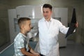 CT scanner with patient and doctor. Doctors examine the child on a tomograph.