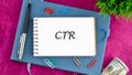 CTR Abbreviation Written in a Notebook Placed on a Table With Greenery and Stationery Items, Symbolizing Financial or Royalty Free Stock Photo