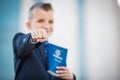 Eight (8) Year Old Boy Holding a Book of Mormon with HIs Fist Closed showing CTR Power Ring