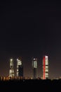 Cuatro Torres Business Area and Caleido Tower at night in madrid Spain with some residential buildings in the front in a vertical Royalty Free Stock Photo