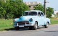 Cuba american blue Oldtimer drives on the road Royalty Free Stock Photo