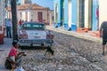 CUBA - APRIL 7, 2016: Tourists and locals visit city streets with typical colourful buildings