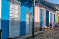 CUBA - APRIL 7, 2016: Tourists visit city streets with typical colourful buildings