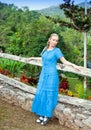 Cuba. The beautiful woman in a long blue dress in park of Soroa (Jardin Botanico Orquideario Soroa)