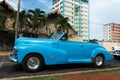 Cuba blue american classic car parked front of a building