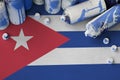 Cuba flag and few used aerosol spray cans for graffiti painting. Street art culture concept