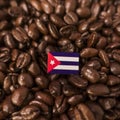 A Cuba flag placed over roasted coffee beans