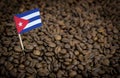 Cuba flag sticking in roasted coffee beans. Concept of export and import
