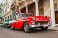 Cuba, Havana: American classic car with cuba flag parked on the Royalty Free Stock Photo