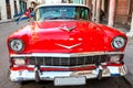 Cuba, Havana: American classic car with cuba flag parked on the Royalty Free Stock Photo