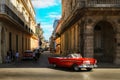 Cuba, Havana - January 16, 2019: Old American red car in the old city of Havana against the backdrop of Spanish colonial architect